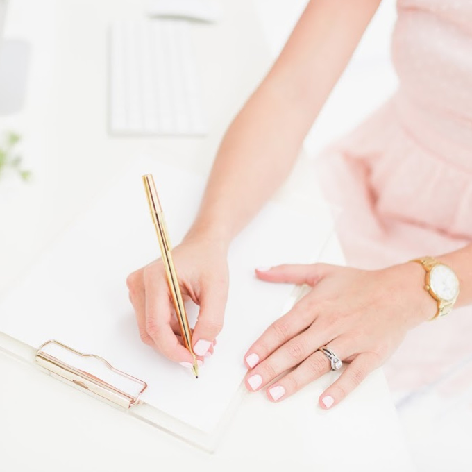 Woman Writing on Clipboard