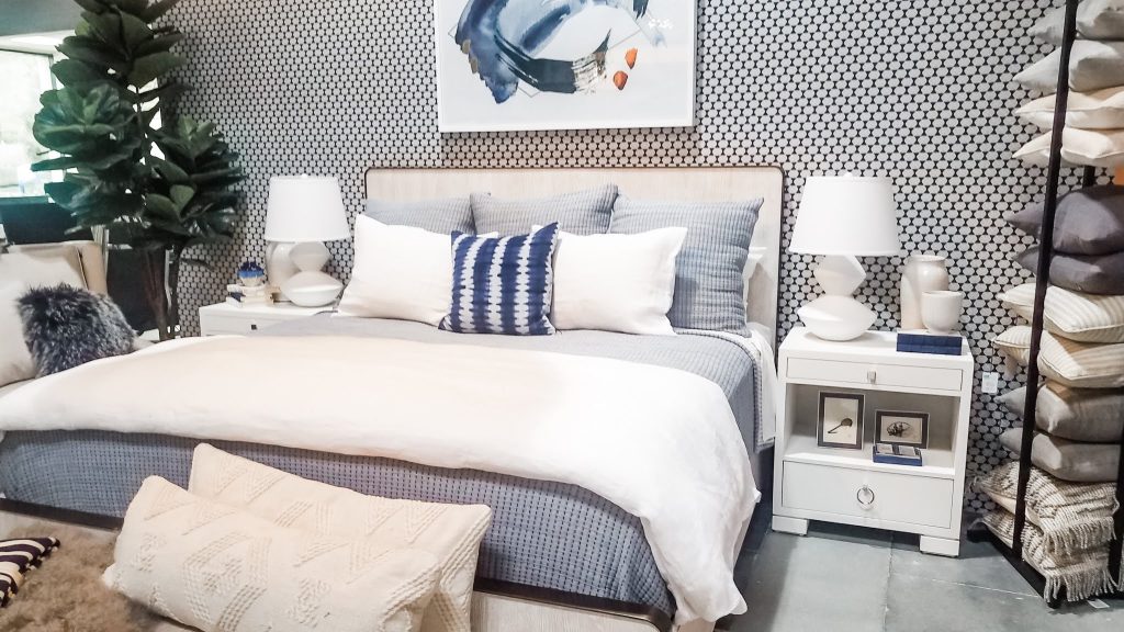 Coastal chic bedroom blue and white patterned wallpaper behind a bed. Nestorations.