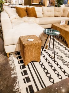 Casual sectional from Four Hands with textured coffee table and end table.