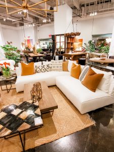 White sofa with textured and earth tone pillows.